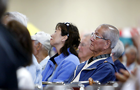 Man Nomura enjoys the performance with the other spectators.